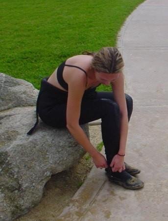 diver donning wetsuit