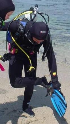 diver putting fins on