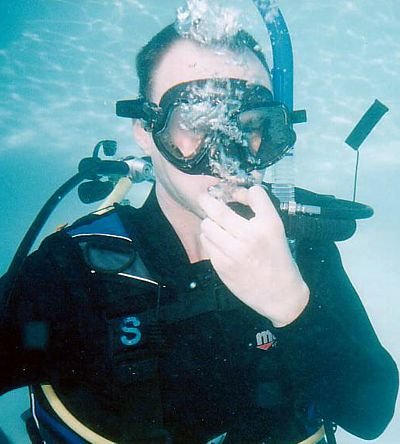 Diver orally inflating BCD