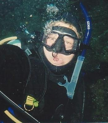 Diver blowing bubbles with regulator out of mouth
