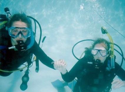 Dive buddies holding hands to stay close