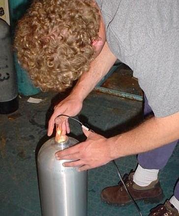 Inspector performing visual inspection of a cylinder