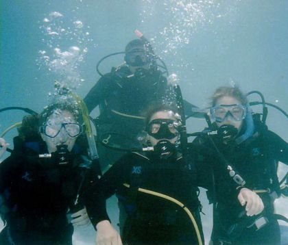 group of divers underwater in a pool
