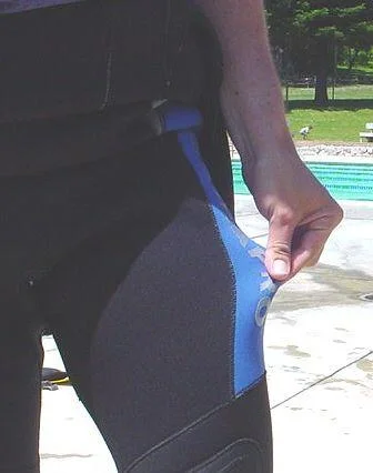 Diver checking fit of wetsuit
